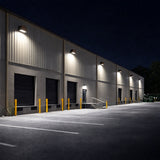 led wall pack at Industrial building with multiple garage doors at night