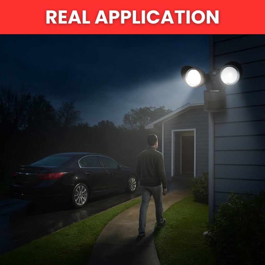 Person walking towards a house with a security light on a dark night.