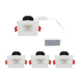 Set of four square recessed ceiling lights with white frames and black lenses on a white background at switchtoled.