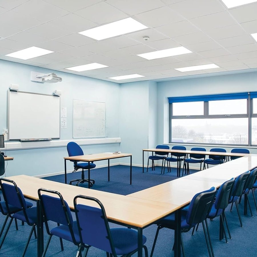 Modern classroom with blue chairs and tables, whiteboards, and large windows.