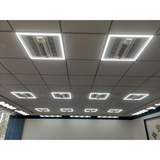 Ceiling with embedded lights and air conditioning units in a room.