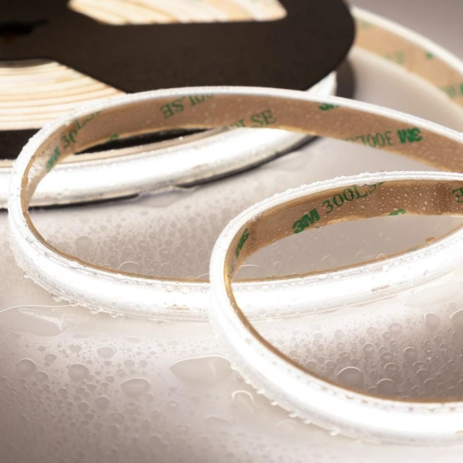 Close-up of a roll of 3M tape with adhesive on a textured surface.