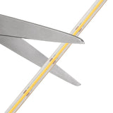 Close-up of a pair of scissors with yellow handles on a white background