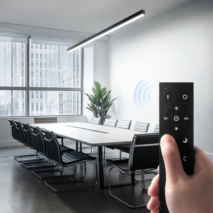 Hand holding a remote control in a modern conference room with large windows.