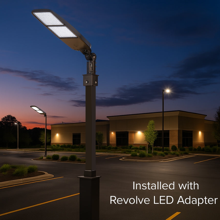 Street light pole with Revolve LED adapter in a parking lot at dusk.