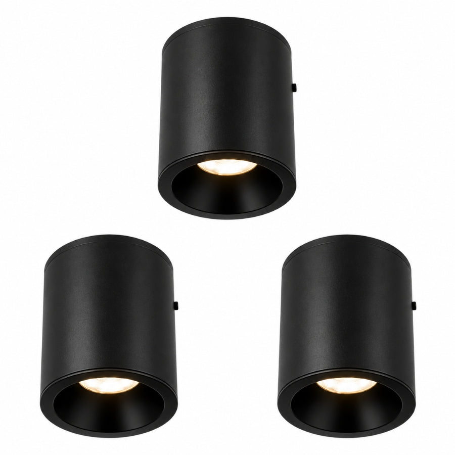 Three black commercial LED surface mount ceiling lights featuring modern cylindrical housings and integrated energy-efficient downlighting.
