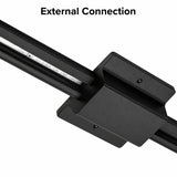 Close-up of a black floating canopy power feed installed on a single circuit track lighting system, showing the external connection between the ceiling junction box and track rail.