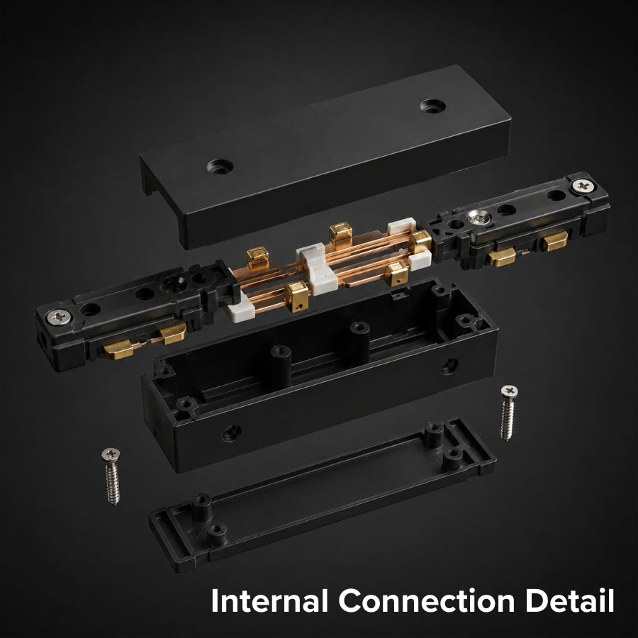 Exploded view of a black inline track lighting power feed connector displaying copper conductors, electrical contacts, durable housing, and precision-engineered internal components for reliable performance.