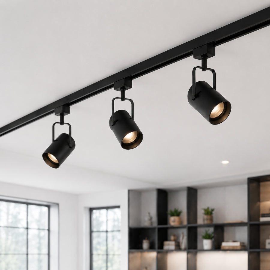 Adjustable magnetic LED spotlight heads mounted on a recessed 4-wire magnetic track rail, providing directional accent lighting for modern interiors.