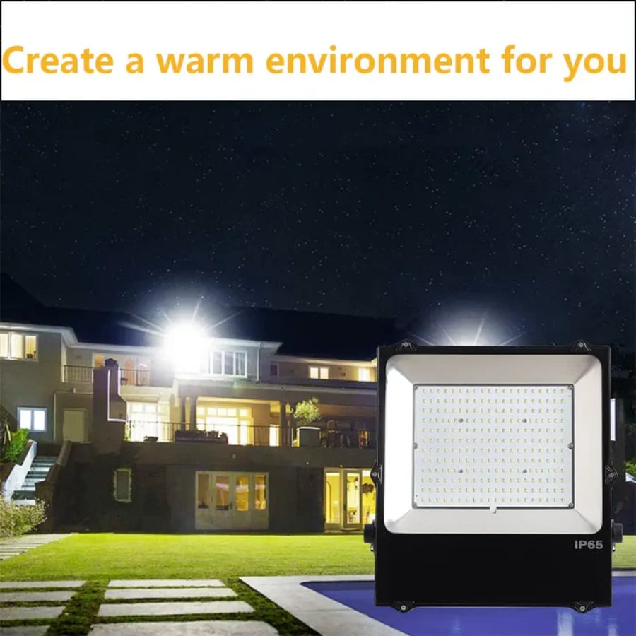 Outdoor flood light illuminating a house at night with text 'Create a warm environment for you'.