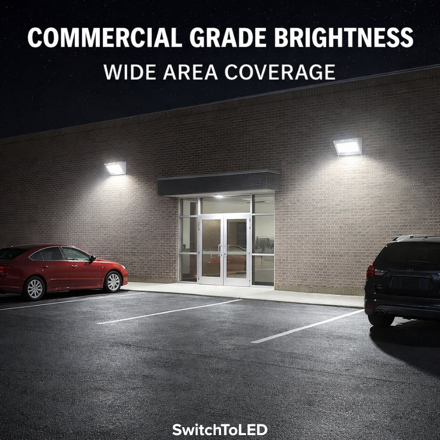 Commercial building with LED lights illuminating a parking area, featuring 'Commercial Grade Brightness' and 'Wide Area Coverage' text.