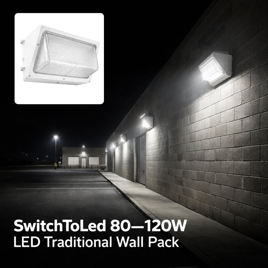 LED traditional wall pack light fixture on a brick wall at night with SwitchToLed branding.