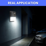 Wall-mounted security light illuminating a dark alleyway with parked cars. wall packs 20w